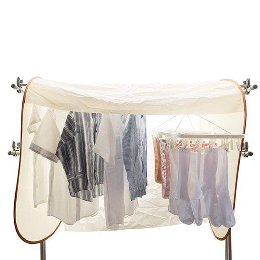 Outdoor laundry cover protecting clothes on a drying rail