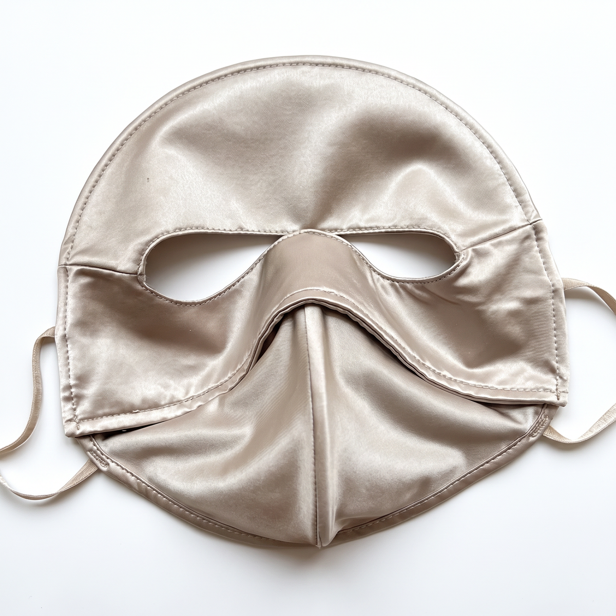 Champagne full face sun mask laid flat on a white background