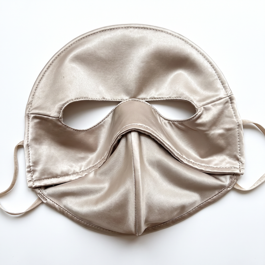 Champagne full face sun mask laid flat on a white background